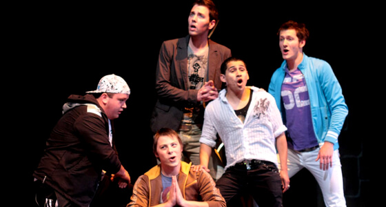 Five male actors standing in unity